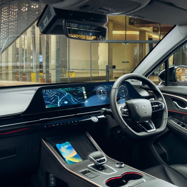 Chery C5 dashboard with wide twin screens and wireless phone charger