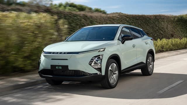 Chery E5 electric SUV driving on a coastal road