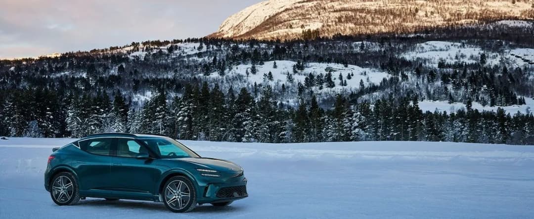 2026 Genesis GV60 front three quarter in a snowy landscape