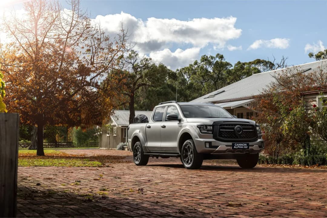 GWM Cannon Alpha Ultra PHEV in silver front three-quarter on a farm driveway