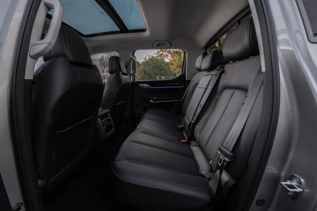 GWM Cannon Alpha rear seats in black leather with the door open