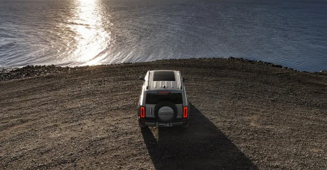 All new GWM Haval H7 from above parked on a lakeside gravel shore
