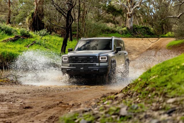 All new GWM Haval H7 splashing through a muddy water crossing