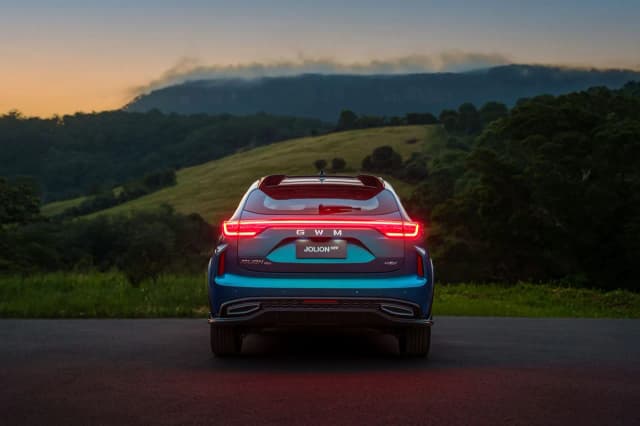 GWM Haval Jolion rear view with tail lights on at dusk