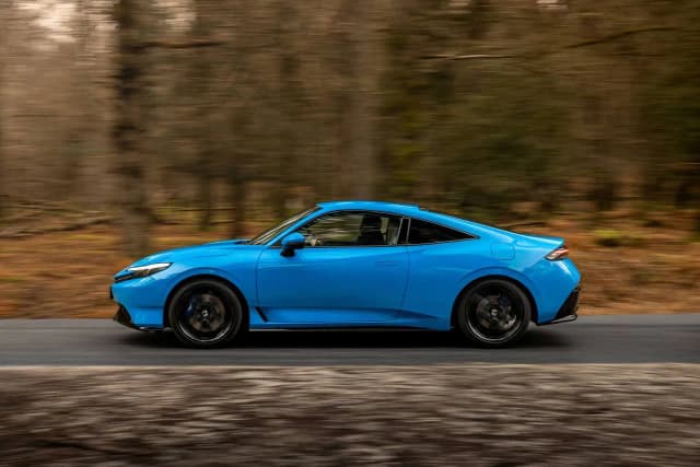 2026 Honda Prelude driving through a forest, side view