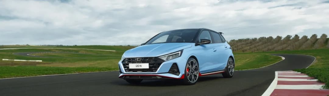 Hyundai i20 N in Performance Blue front three quarter on a race track