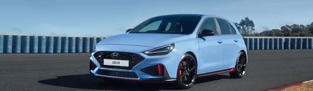 Hyundai i30 N hatch in Performance Blue front three quarter on a race track