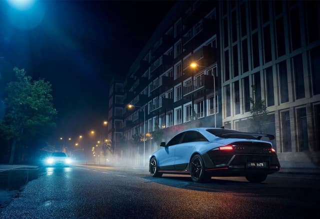 Hyundai Ioniq 6 N rear three quarter on a city street at night