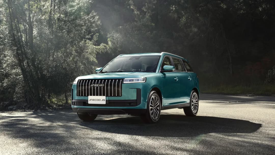 Jaecoo J5 in teal front three-quarter on a forest road