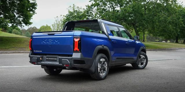 KGM Musso EV rear three-quarter view showing the tub and tail lights
