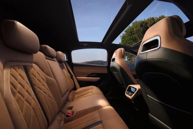 Mazda 6e tan leather rear seats under the panoramic glass roof