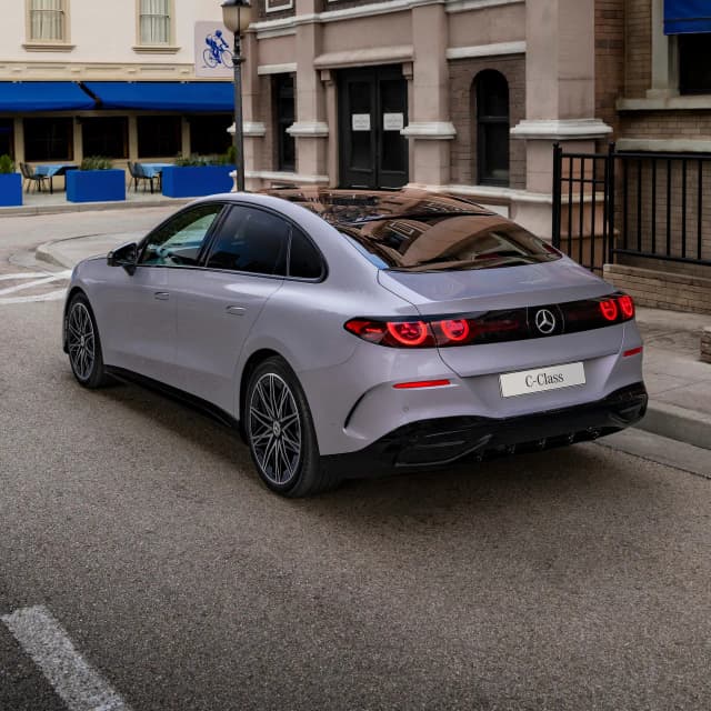 Mercedes-Benz C-Class electric sedan rear three quarter view on a city street