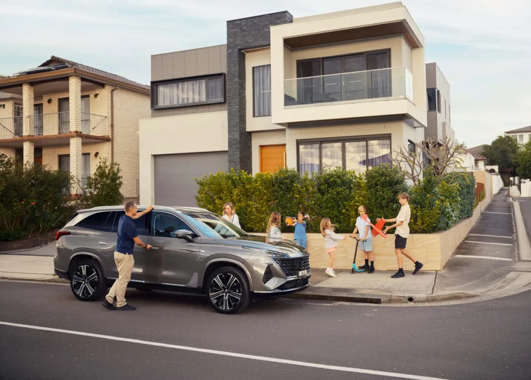MG QS seven seat SUV parked outside a family home