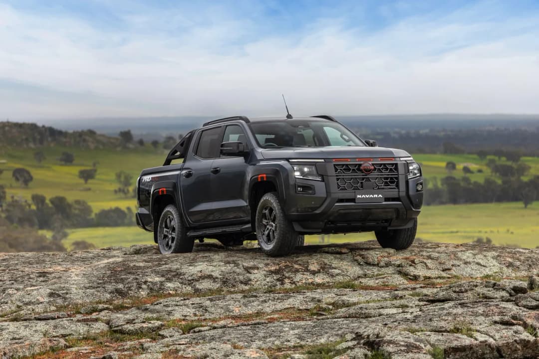 2026 Nissan Navara Pro-4X front three-quarter parked on a rocky outcrop