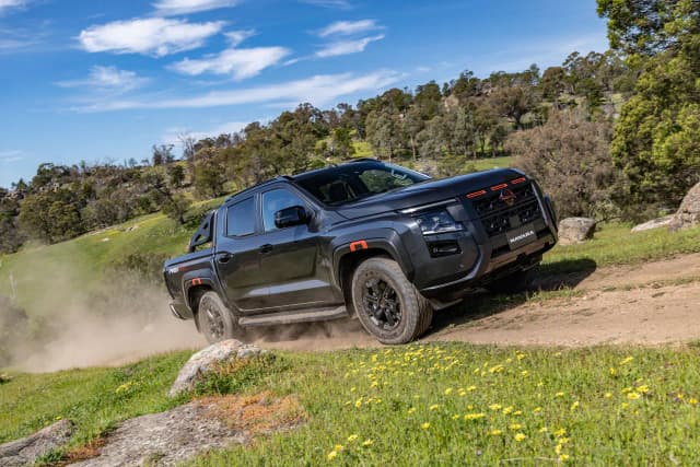 2026 Nissan Navara Pro-4X driving up a grassy hill track