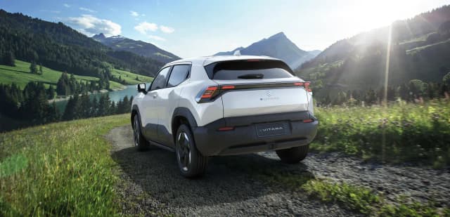 Suzuki e Vitara rear three-quarter on a mountain track