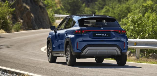 Suzuki Fronx Hybrid rear view driving on a mountain road