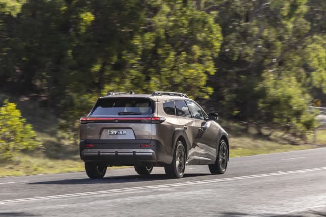 2026 Toyota bZ4X Touring, rear three-quarter view on the road