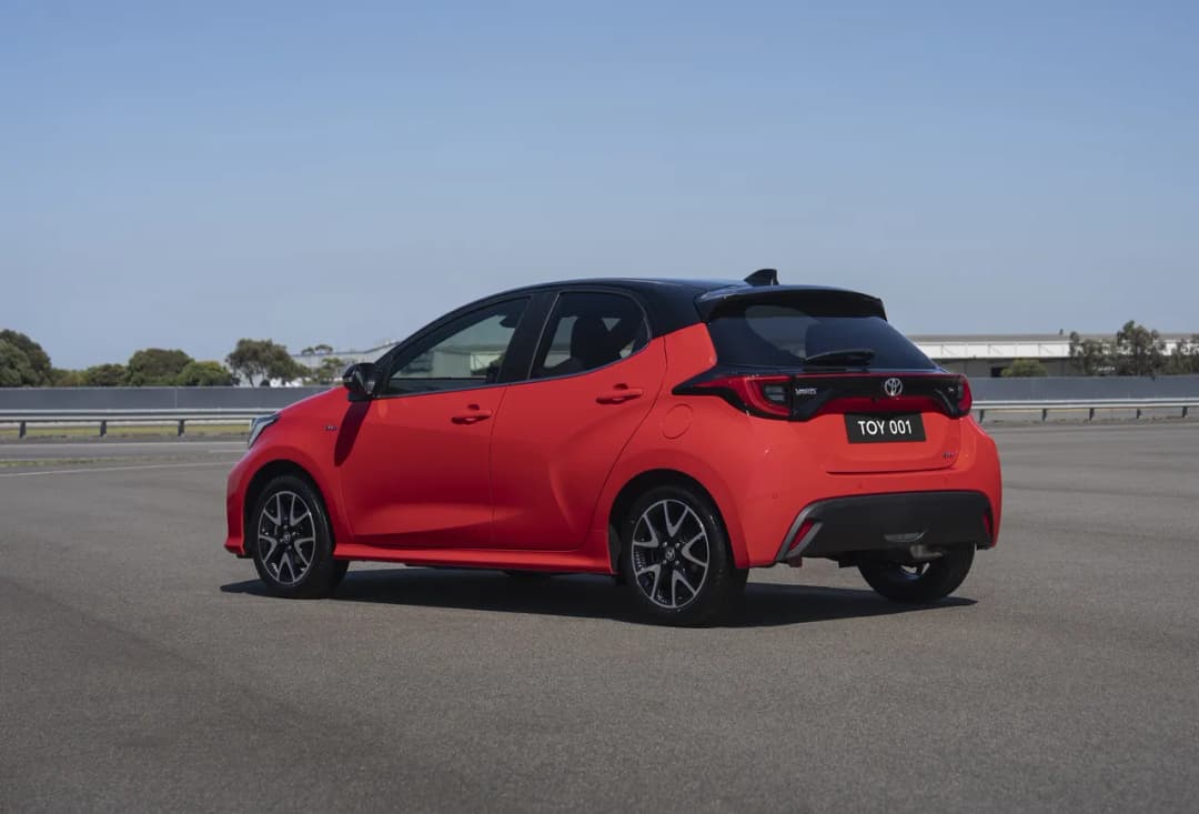 Toyota Yaris ZR hybrid hatch in red, rear three-quarter view