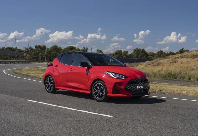 Toyota Yaris ZR hybrid hatch in red driving on a test track