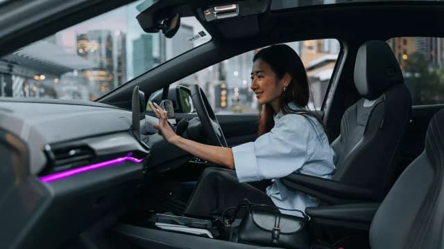 Volkswagen ID.5 cabin with ambient lighting and driver at the wheel