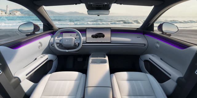 XPeng L03 dashboard with 15.6 inch touchscreen and light grey seats, left hand drive car shown